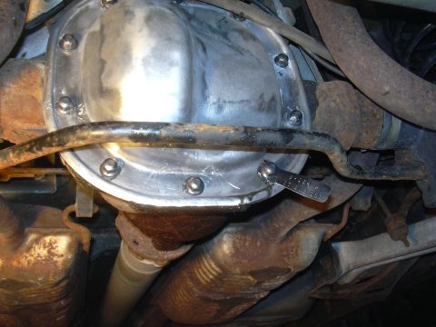 1996 Ford Crown Victoria - Close-up of a rear differential cover with a torque wrench indicating a measurement.