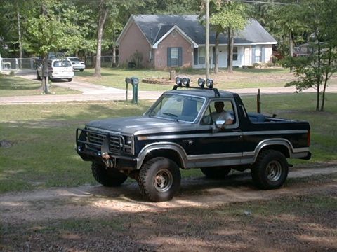 1980 Ford Bronco - This 1980 Ford Bronco features a prominent brush guard and auxiliary lights mounted on the roof rack.
