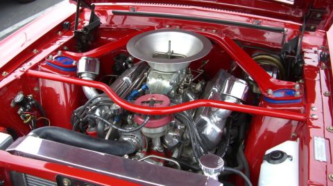 1990 Ford Probe - Close-up view of a polished engine bay a prominent air intake and red structural bracing.
