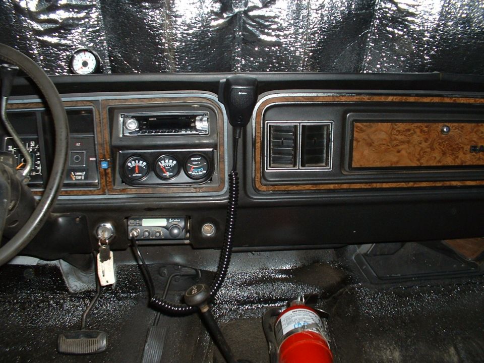 1978 Ford Bronco interior showing dashboard, steering wheel, gauges, radio, and fire extinguisher