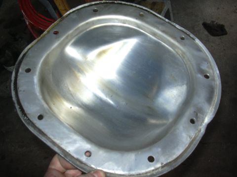 1996 Ford Crown Victoria - A person is holding a metal differential cover, likely for a vehicle repair or upgrade.
