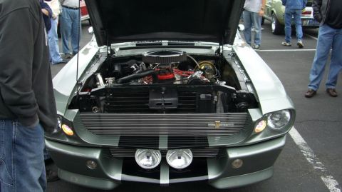 1990 Ford Probe - The front of a 1967 Ford Mustang Shelby GT500 is shown with its hood open, revealing the engine bay.