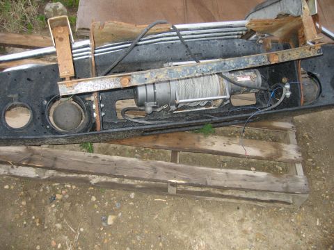 1996 Dodge 2500 - Winch and bumper assembly, possibly for a truck, resting on wooden pallets.