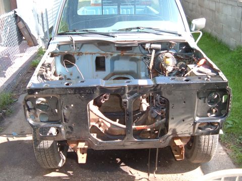 1990 Ford Ranger - Front view of a 1990 Ford Ranger pickup truck with its engine and front clip removed for work.