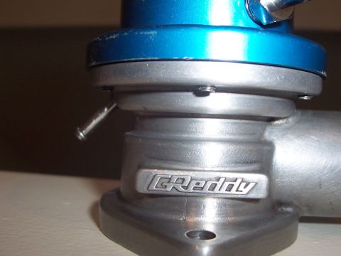 1993 Ford Probe - Close-up of a GReddy blow-off valve, a performance automotive part.