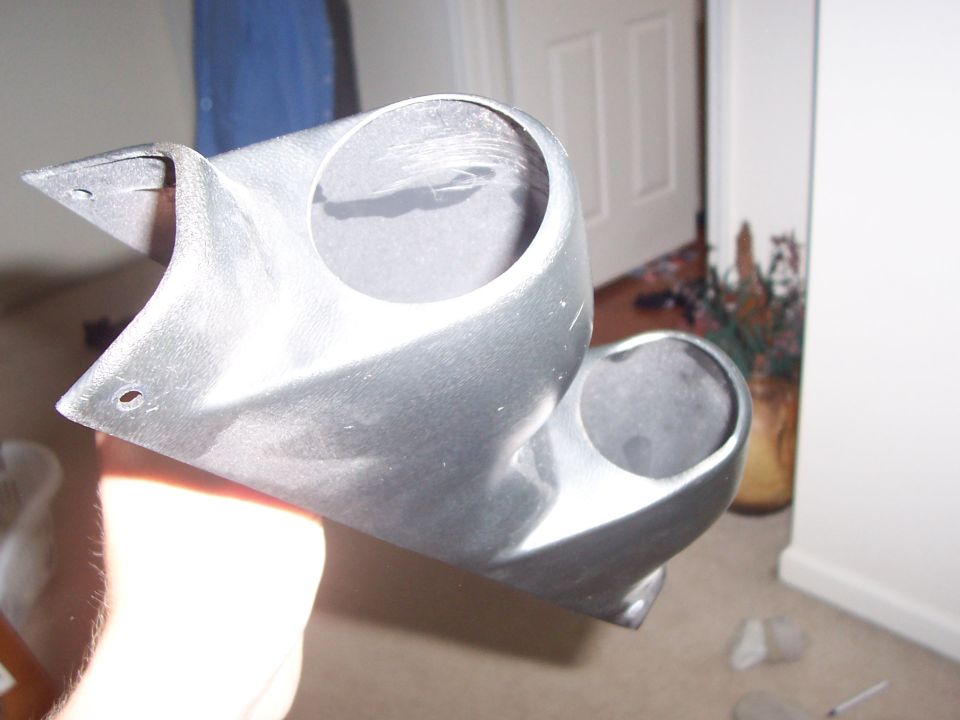 Silver plastic gauge pod with two circular openings