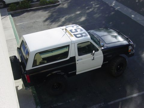 1994 Ford Bronco - A black and white Ford Bronco is parked outdoors, viewed from above.