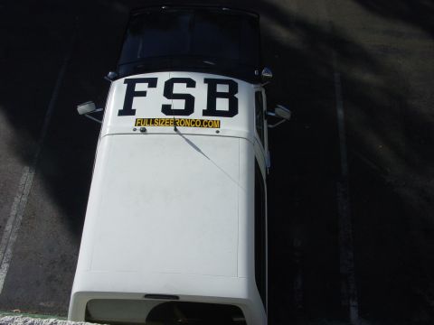 1994 Ford Bronco - This white Bronco features prominent 'FSB' and 'FULLSIZEBRONCO.COM' lettering on its roof.