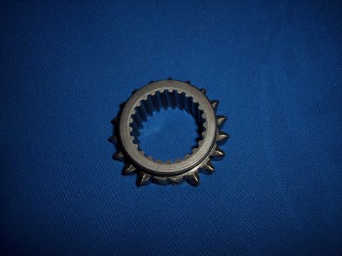1972 Ford Ranchero - A close-up view of a metal gear synchronizer ring, internal splines and external teeth against a blue background.