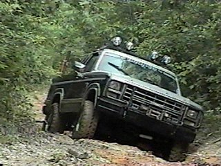 1980 Ford Bronco - 1980 Ford Bronco navigating a challenging off-road course.