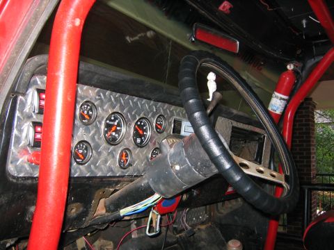 1979 Ford Bronco - Interior view of a 1979 Ford Bronco with a custom dashboard and roll cage.