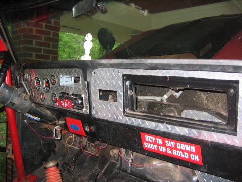 1979 Ford Bronco - The dashboard features diamond plate accents and numerous gauges, indicating custom modifications.