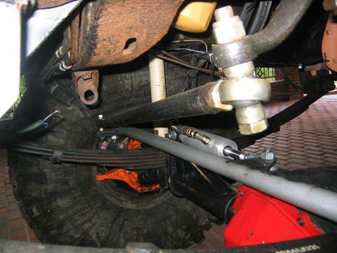 1979 Ford Bronco - Close-up view of the vehicle's undercarriage, focusing on suspension and steering mechanisms.