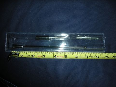 1998 Ford Crown Victoria - A set of automotive dipsticks and probes is shown next to a tape measure for scale.