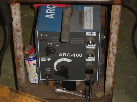 1989 Ford Bronco - A close-up view of an ARC-180 welding machine, showing its control panel and various connections.