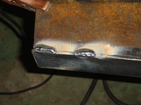 1989 Ford Bronco - Close-up of welding on a rusty metal component, showing the joining process.