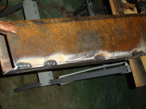 1989 Ford Bronco - Close-up of a welded metal beam showing signs of rust and repair work.