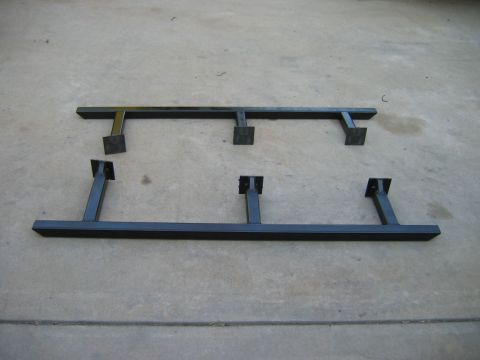 1985 Toyota 4Runner - Black metal running boards with mounting brackets are displayed on a concrete surface.