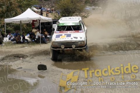 1992 Ford Explorer - Modified truck navigates a muddy course during an off-road race event.