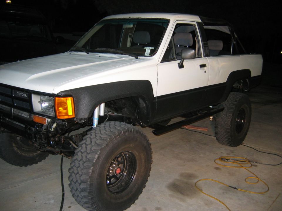 White and black 1985 Toyota 4Runner with lifted suspension and off-road tires