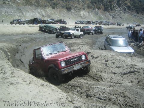 1987 Suzuki Samurai - A group of off-road vehicles are stuck in the mud at a popular off-roading spot.