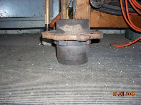 2000 Chevrolet Tahoe - A rusted wheel hub assembly with a 6-lug bolt pattern is shown in a workshop setting.