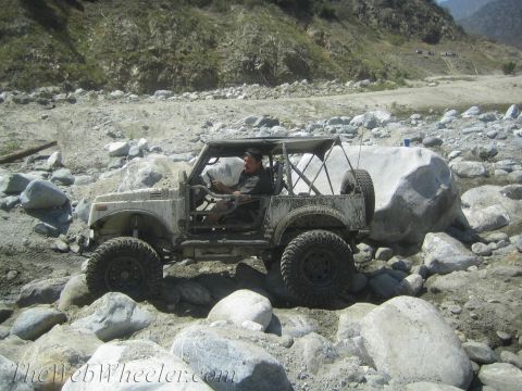 1987 Suzuki Samurai - A driver navigates a modified Suzuki Samurai through a challenging rocky off-road course.