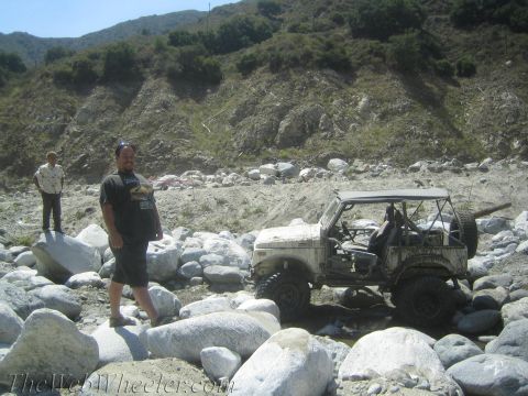 1987 Suzuki Samurai - A white 1987 Suzuki Samurai navigates a rocky stream bed during an off-road excursion.