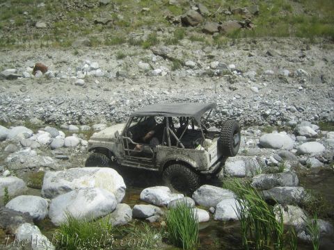 1987 Suzuki Samurai - This 1987 Suzuki Samurai navigates a rocky stream bed, its off-road capabilities.