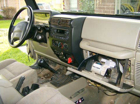 2004 Jeep Wrangler - The interior of a Jeep Wrangler, an aftermarket air compressor mounted inside the glove box.