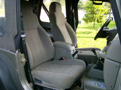2004 Jeep Wrangler - Interior view of a 2004 Jeep Wrangler, showing the front seats and dashboard area.