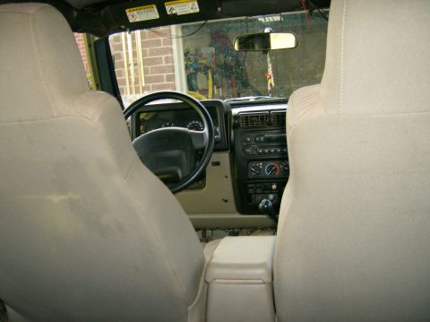 2004 Jeep Wrangler - Interior view of a 2004 Jeep Wrangler, highlighting the dashboard and seating.