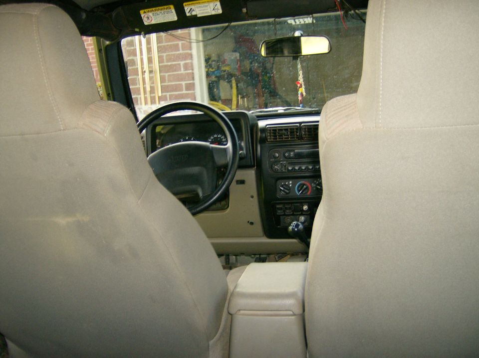 2004 Jeep Wrangler interior showing dashboard, steering wheel, and seats