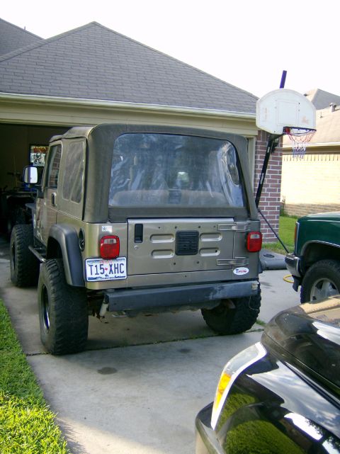 2004 Jeep Wrangler - Rear view of a 2004 Jeep Wrangler, showing its soft top and license plate.