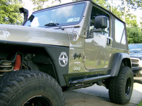 2004 Jeep Wrangler - This Jeep Wrangler shows off its off-road modifications, including a snorkel and large tires.