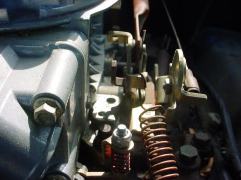 1992 Ford Mustang - Detailed view of the mechanical linkage and springs within a vehicle's carburetor system.