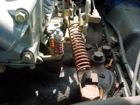 1992 Ford Mustang - Carburetor linkage and springs are visible in this close-up view.
