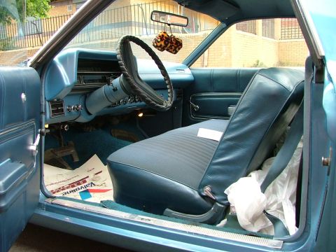 1970 Ford Ranchero - Interior view of a 1970 Ford Ranchero, showing the dashboard, seats, and door panel.