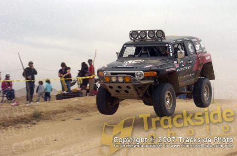 1992 Ford Explorer - This modified Toyota FJ Cruiser is captured mid-air during an off-road event.