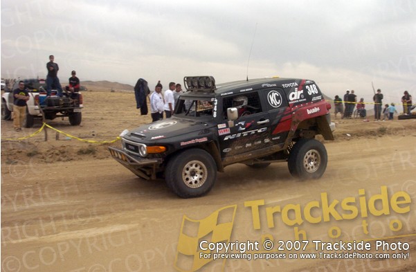 Black Toyota FJ Cruiser with racing decals and number 348 on a dirt track
