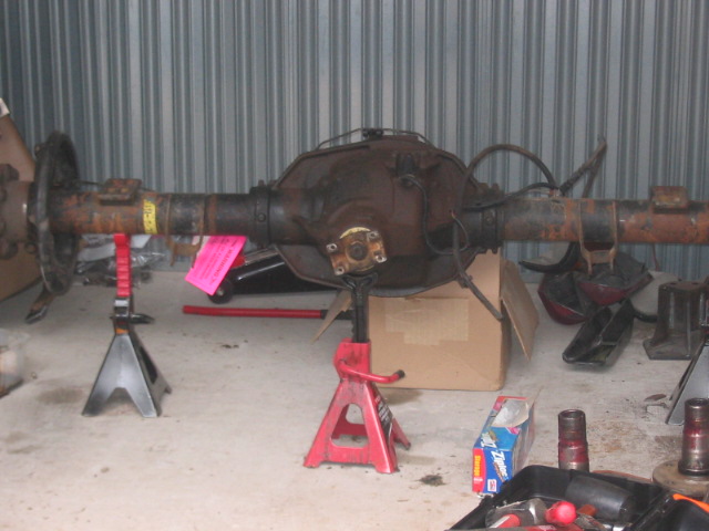 Rear axle assembly on jack stands, with yellow and pink tags