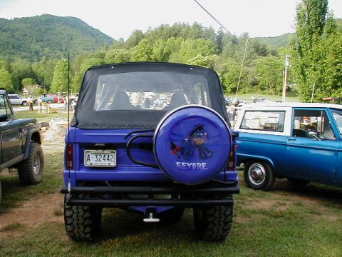1990 Ford Bronco - Rear view of a 1990 Ford Bronco, a custom spare tire cover and another Bronco parked alongside.