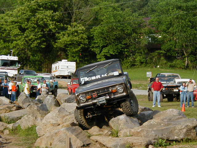 Bronco climbing over rocks, windshield has 'CBR SA' sticker