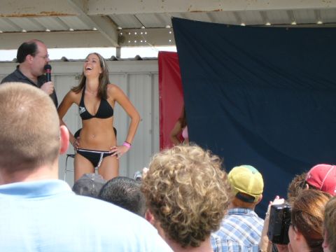 1978 Ford Bronco - A woman participates in a bikini contest on a stage, with an audience watching.