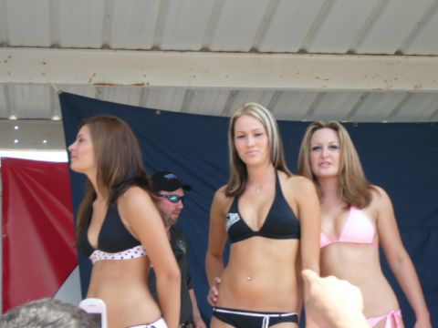 1978 Ford Bronco - A swimsuit contest features three women posing on a stage.
