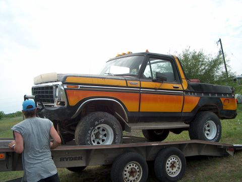 1979 Ford Bronco - This 1979 Ford Bronco, with its distinctive orange and black stripe pattern, is being loaded onto a flatbed trailer.