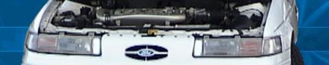 1993 Ford Taurus - Front view of a 1993 Ford Taurus with the hood open, revealing the engine compartment.