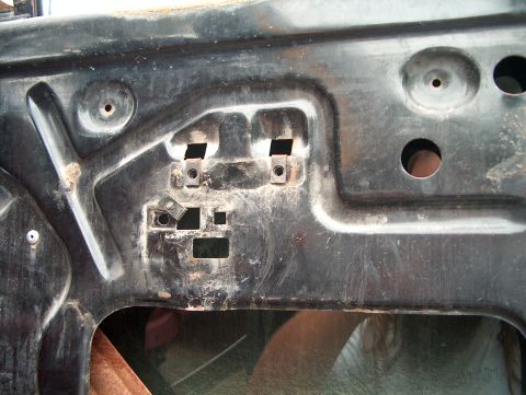 1979 Ford Bronco - The interior of a vehicle door panel shows the internal structure and mounting points for components.