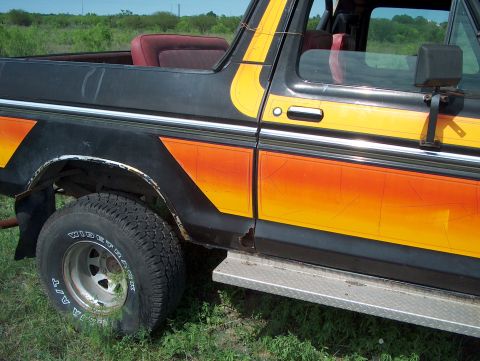1979 Ford Bronco - This 1978 Ford Bronco shows signs of wear and tear, including rust and a flat tire.