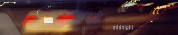 Rear of a car at night with taillights illuminated and a license plate